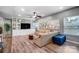Bright living room boasts hardwood floors, custom built-ins, modern ceiling fan, and neutral paint at 2065 Taney Way, Indian Land, SC 29707