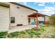 Patio with pergola-covered seating, a stone fire pit, and grilling area for outdoor relaxation at 2065 Taney Way, Indian Land, SC 29707