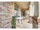 Cozy brick porch with seating and greenery, perfect for relaxing outdoors at 2065 Taney Way, Indian Land, SC 29707