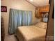 Comfortable bedroom featuring a queen bed, storage, and soft natural light at 207 Deer Park Rd, Mount Gilead, NC 27306