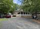 Charming home with a covered front porch, ample parking, and mature trees at 207 Deer Park Rd, Mount Gilead, NC 27306