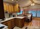 Traditional kitchen featuring wood cabinets, tile flooring, and modern appliances at 207 Deer Park Rd, Mount Gilead, NC 27306