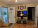 Inviting living room featuring a TV, an exterior door, and hardwood floors at 207 Deer Park Rd, Mount Gilead, NC 27306