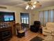 Relaxing living area featuring an electric fireplace, a rocking chair, and wood flooring at 207 Deer Park Rd, Mount Gilead, NC 27306