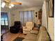 Comfortable living room showcasing hardwood floors, a reading lamp, and ample seating at 207 Deer Park Rd, Mount Gilead, NC 27306