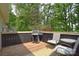 Back deck with wood flooring featuring a grill and outdoor seating with leafy view at 216 Dewars Dr, Rock Hill, SC 29730