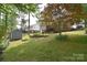 Expansive backyard featuring a shed, mature trees, and lush greenery at 216 Dewars Dr, Rock Hill, SC 29730