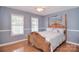 Inviting bedroom with hardwood floors, bright windows, and decorative wooden bed frame at 216 Dewars Dr, Rock Hill, SC 29730