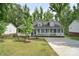 Charming home with a welcoming front porch, blue shutters, and well-manicured lawn at 216 Dewars Dr, Rock Hill, SC 29730