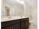 Bathroom features a double sink vanity with dark cabinets, tub and shower combo, and large mirror at 23112 Clarabelle Dr, Charlotte, NC 28273