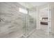 Large glass-enclosed shower featuring neutral tile work, a small window, and glass shelving at 23112 Clarabelle Dr, Charlotte, NC 28273