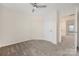 Bedroom with plush carpeting, neutral walls, ceiling fan, and bright natural light at 23112 Clarabelle Dr, Charlotte, NC 28273