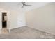 Bright bedroom features neutral walls, plush carpeting, and a ceiling fan for added comfort at 23112 Clarabelle Dr, Charlotte, NC 28273