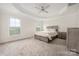 Large primary bedroom with a tray ceiling, neutral walls, plush carpeting, and ample natural light at 23112 Clarabelle Dr, Charlotte, NC 28273
