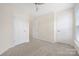 Carpeted bedroom with neutral paint, a ceiling fan, and two doorways to other rooms at 23112 Clarabelle Dr, Charlotte, NC 28273