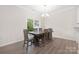 Dining room with a large wood table, chandelier, and sliding doors to an outdoor space at 23112 Clarabelle Dr, Charlotte, NC 28273