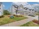 Exterior view of townhomes with manicured lawns and convenient parking; perfect community living at 23112 Clarabelle Dr, Charlotte, NC 28273