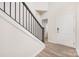 Bright foyer featuring wood-look flooring, a staircase with metal spindles, and white trim throughout at 23112 Clarabelle Dr, Charlotte, NC 28273