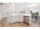 Stylish kitchen showcasing white cabinets, stainless steel appliances, and a cozy dining area at 23112 Clarabelle Dr, Charlotte, NC 28273