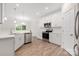 Modern kitchen featuring stainless steel appliances, white cabinets, and sleek countertops at 23112 Clarabelle Dr, Charlotte, NC 28273