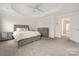 Spacious main bedroom featuring neutral walls, tray ceiling with ceiling fan, and ensuite bath at 23112 Clarabelle Dr, Charlotte, NC 28273