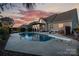 Stunning backyard pool with sunset sky, surrounded by well-maintained landscaping and inviting outdoor space at 234 Deal Estate Dr, China Grove, NC 28023