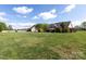 Large backyard with lush green grass and plenty of space, surrounded by trees and neighboring houses at 234 Deal Estate Dr, China Grove, NC 28023