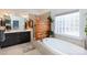 Bright bathroom with tub, shower and stylish glass block window at 234 Deal Estate Dr, China Grove, NC 28023