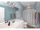 Clean bathroom with white vanity, large mirror, and shower-tub combination at 234 Deal Estate Dr, China Grove, NC 28023