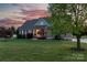Charming home with well-kept lawn and inviting entry, framed by a picturesque sunset at 234 Deal Estate Dr, China Grove, NC 28023