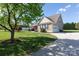 Charming home with stone accents, well-manicured lawn, and a long driveway leading to a garage at 234 Deal Estate Dr, China Grove, NC 28023