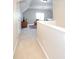 Upstairs hallway leads to a cozy living space with vaulted ceilings at 234 Deal Estate Dr, China Grove, NC 28023