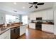 Open kitchen with white cabinets, dark appliances, and view of dining area at 234 Deal Estate Dr, China Grove, NC 28023