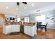Open-concept kitchen with an island, white cabinets, and a view of the dining and living areas at 234 Deal Estate Dr, China Grove, NC 28023