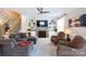 Cozy living room with a fireplace, built-in shelving, comfortable seating, and natural light at 234 Deal Estate Dr, China Grove, NC 28023