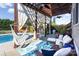 Relaxing outdoor patio featuring a pergola, hammocks, comfortable seating, and a swimming pool at 234 Deal Estate Dr, China Grove, NC 28023