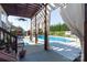 Outdoor pool area with pergola, curtains, ceiling fan, and lounge chairs, perfect for relaxation at 234 Deal Estate Dr, China Grove, NC 28023