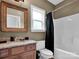 Bathroom featuring a vanity with granite top, toilet, and shower-tub combo at 2553 Fallbrook Nw Pl, Concord, NC 28027