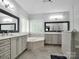 Luxurious bathroom with double vanities, soaking tub, glass shower and decorative mirrors at 2553 Fallbrook Nw Pl, Concord, NC 28027