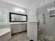 Bathroom showcasing a glass shower, soaking tub, and double sinks at 2553 Fallbrook Nw Pl, Concord, NC 28027