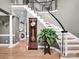 Elegant foyer with curved staircase, wood floors, and decorative accents at 2553 Fallbrook Nw Pl, Concord, NC 28027