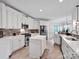 Bright kitchen with stainless steel appliances, white cabinetry and an island at 2553 Fallbrook Nw Pl, Concord, NC 28027