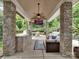 Outdoor kitchen and entertainment area with a built-in grill, seating, and a TV for ultimate outdoor enjoyment at 2553 Fallbrook Nw Pl, Concord, NC 28027