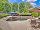 Lush backyard pool and spa with waterfall features, surrounded by mature trees and landscaping for privacy at 2553 Fallbrook Nw Pl, Concord, NC 28027