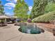 Lush backyard oasis featuring a stunning pool, waterfalls, and an outdoor living area for relaxation and entertainment at 2553 Fallbrook Nw Pl, Concord, NC 28027