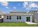 Rear exterior showcasing the home's neutral siding, windows, and a sliding glass door to the backyard at 2573 Blue Sky Meadows Dr, Monroe, NC 28110