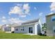 Back of home with sliding glass door, neutral siding and a well-maintained lawn at 2573 Blue Sky Meadows Dr, Monroe, NC 28110