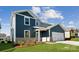 Charming two-story home with two-car garage and neutral siding, complemented by a well-maintained lawn at 2573 Blue Sky Meadows Dr, Monroe, NC 28110