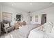 Serene main bedroom featuring neutral decor, a round mirror, and ample natural light at 2573 Blue Sky Meadows Dr, Monroe, NC 28110