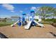 Community playground featuring slides, climbing structures, and a cushioned ground surface for safe play at 2573 Blue Sky Meadows Dr, Monroe, NC 28110